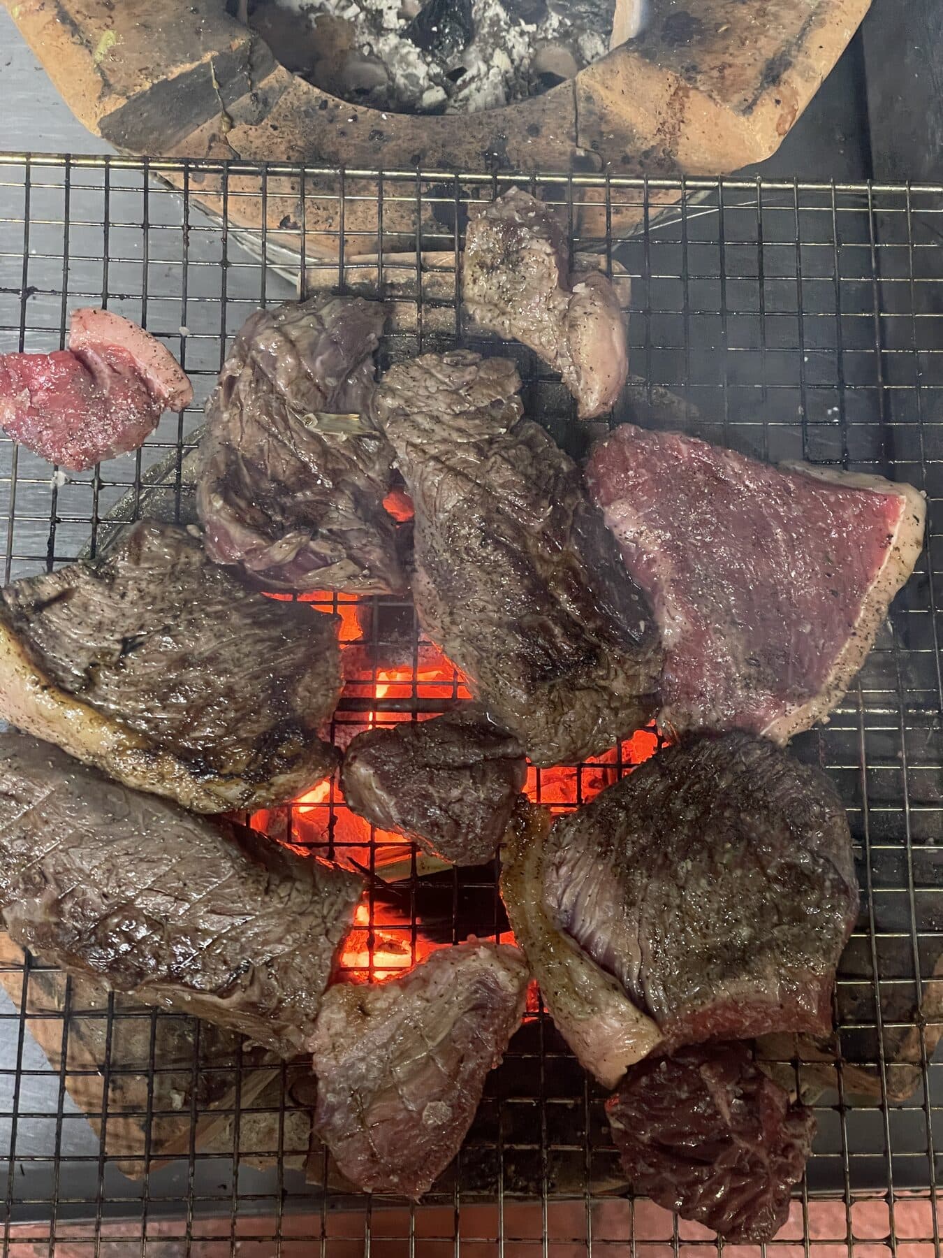 Beef grilling over charcoal